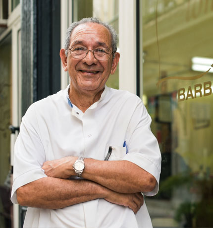 barber standing out front of his shop