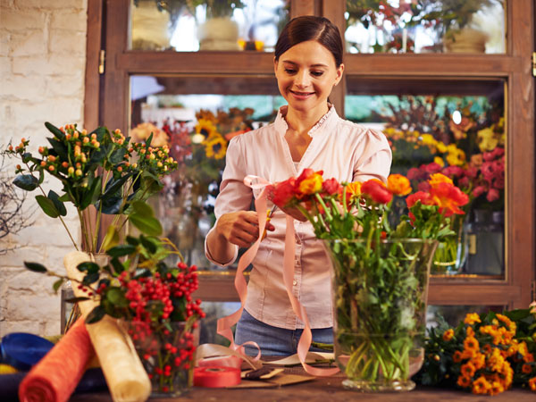 florist preparing a flower arrangement for a customer