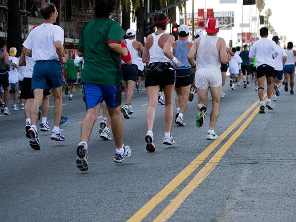 Large group of people running a road race